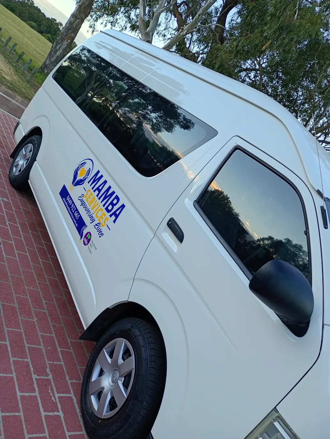 Side view of the Mamba Services van with the passenger sliding door and branding
